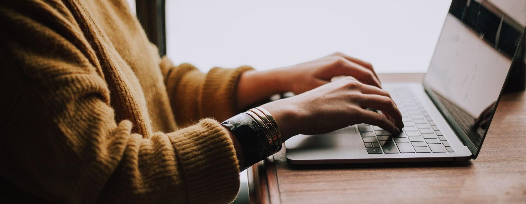 a person typing on a laptop